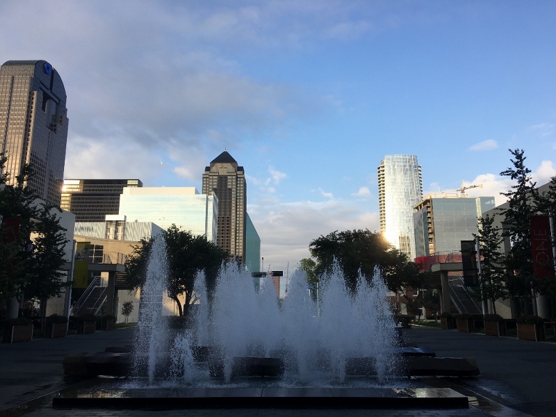 A shot of downtown Dallas from the One Arts Center with water fountains in the foreground.